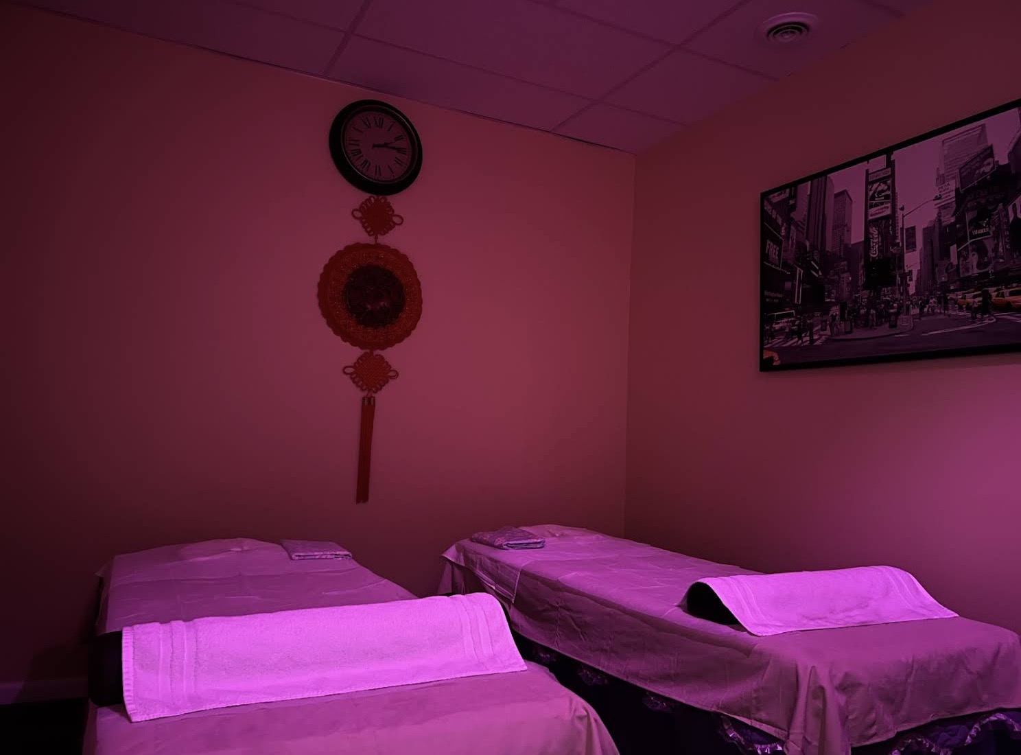 Warm couples massage room with multiple treatment beds at Four Seasons Spa