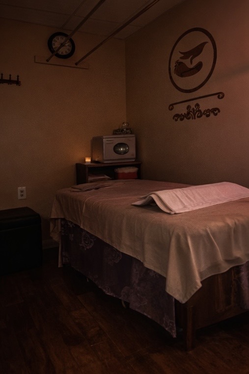 Private massage room with treatment table and folded towels at Four Seasons Spa
