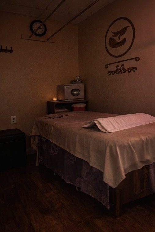 Private massage room with treatment table and folded towels at Four Seasons Spa